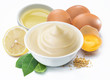 Mayonnaise sauce in white bowl with mayonnaise ingredients.
