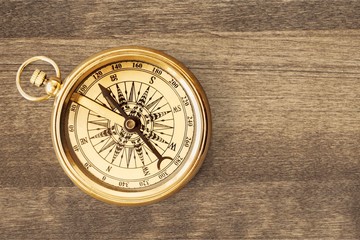 Wall Mural - Brass antique compass on wooden background