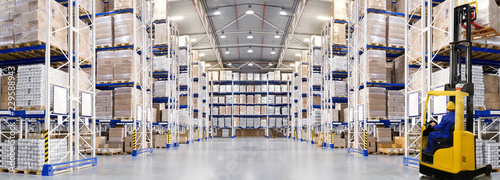 Fotografía Huge distribution warehouse with high shelves and forklift