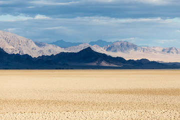 Wall Mural - Dramatic mountain shadows at Soda dry lake in the Mojave National Preserve near Zzyzx and Baker in San Bernardino County, California.  