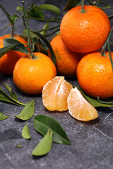 fresh ripe tangarines, food closeup on grey background