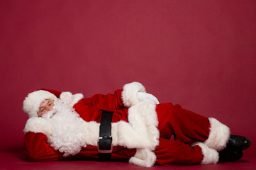 Santa Clause lying on red background, Christmas and New year concept