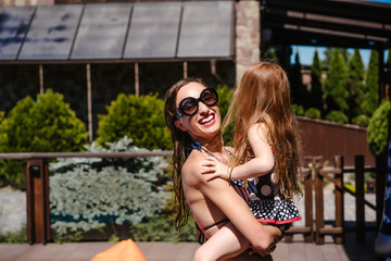 Wall Mural - Mom holds her daughter in her arms