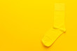 © Ruslan Grumble - pair of socks on bright yellow background. top view of yellow socks with copy space