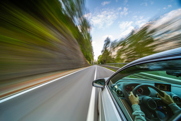 Wall Mural - Car in motion blur driving in the Mountains