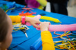 Happy children girl's hands with balloon on twisting art workshop