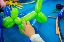 Boy's Hands With Balloon Animal Toy On Twisting Art Workshop