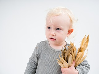 Wall Mural - Baby in  with colorful  pumpkins on white background  