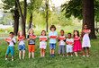 © Evgeniy Kalinovskiy - a group of cheerful happy children eat a ripe watermelon in the Park on the grass on a Sunny summer day