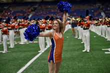 Young College Cheerleader Performing At A College Football Game
