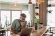 © Westend61 - Businessman using laptop at cafe
