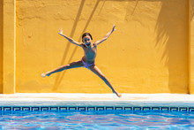 Portrait Of Girl Jumping In Swimming Pool