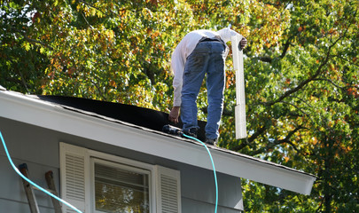 Wall Mural - worker install new shingle on the roof of the house for roof repair