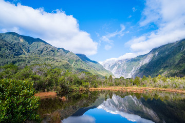 Wall Mural - Beautiful landscape of the mountain and the reflection on the lake. Amazing greenery.