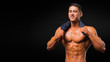 © Stavros - Man with torso, muscular macho with six packs, dark background. Man smiley face with muscular figure, sportsman, bodybuilder.