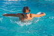 © RaDa - Close up action shot of teenage boy, young athlete swimming butterfly stroke. Sport, recreation, lifestyle concept.