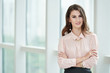 © DragonImages - Portrait of beautiful confident businesswoman standing with her arms folded