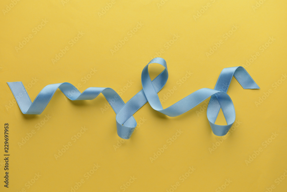 Beautiful blue ribbon on color background