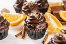 Delicious Chocolate Cupcake With Orange On Wooden Table