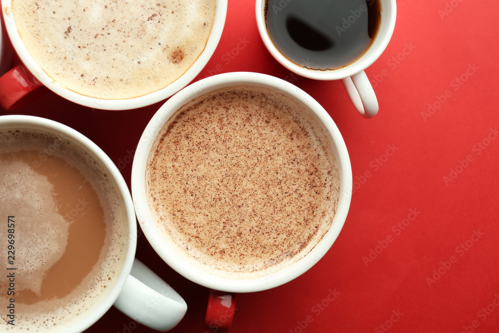 Cups with tasty aromatic coffee on color background, flat lay