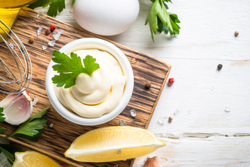 Mayonnaise sauce on white stone table. 