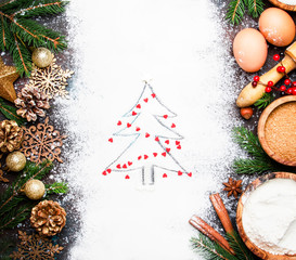 Christmas or New Year baking background with Christmas tree painted on flour with decorations of red hearts, top view