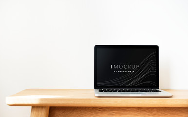 Wall Mural - laptop screen mockup on a wooden table