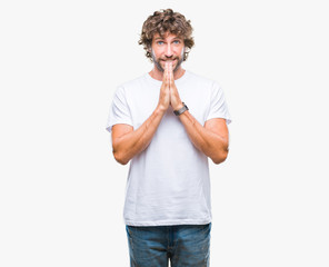 Sticker - Handsome hispanic model man over isolated background praying with hands together asking for forgiveness smiling confident.