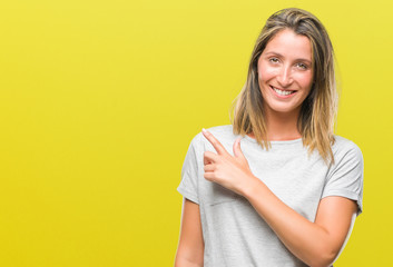 Poster - Young beautiful woman over isolated background cheerful with a smile of face pointing with hand and finger up to the side with happy and natural expression on face looking at the camera.