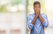 © Krakenimages.com - Young african american business man over isolated background shocked covering mouth with hands for mistake. Secret concept.