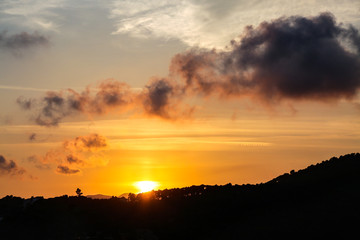 Silhouette of hill at summer sunset. Evening colorful sky. Natural background.