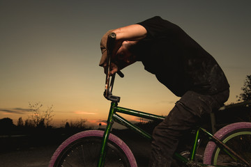 Wall Mural - Young man standing bmx bike. BMX rider with and a sunset