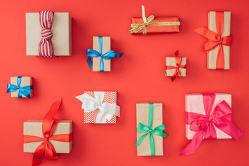 Wall Mural - flat lay with arrangement of wrapped christmas presents isolated on red