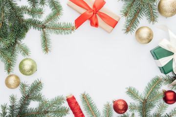 Wall Mural - flat lay with arranged pine tree branches, gifts and christmas toys isolated on white