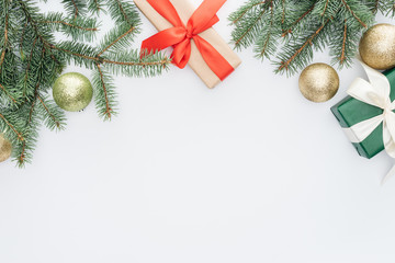 Wall Mural - flat lay with arranged pine tree branches, gifts and christmas toys isolated on white