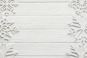 Wall Mural - flat lay with decorative snowflakes on white wooden tabletop