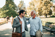 © bnenin - Father and son walking in the park.