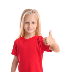 Wall Mural - Cute little girl in t-shirt showing thumb-up on white background