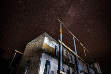 Wall Mural - night sky and the milky way over the old abandoned house