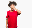 © Krakenimages.com - Young afro american woman over isolated background smiling and laughing with hand on face covering eyes for surprise. Blind concept.