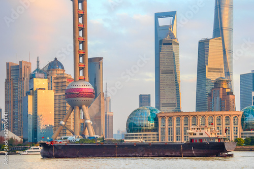 Barge by sunset Shanghai skyline