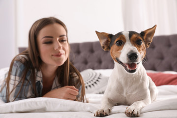 Canvas Print - Beautiful woman with her dog lying in bed at home