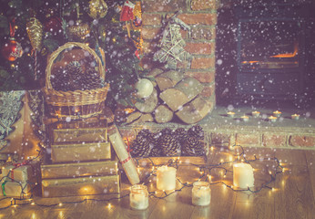 Wall Mural - Beautiful Christmas setting, decorated lit up Christmas tree with baubles and ornaments, fireplace with woodburner, lantern, stars and garlands, created snow, toned, selective focus