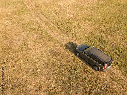 Fotografía aerial top view of car isolated on summer field texture background f