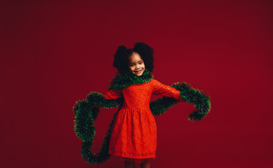 Kid playing with a decorative ribbon