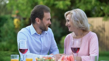 Wall Mural - Successful adult son thanking mother for upbringing, emotional embrace love