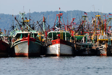 A fleet of fishing boats moored at port in Asia