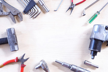 Many tools are placed on the white wood floor.