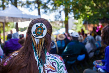 Woman Is Wearing A Large Turtle Beaded Hair Pin And Colorful Native Clothing While Listening To A Concert As Part Of A Native Arts Festival