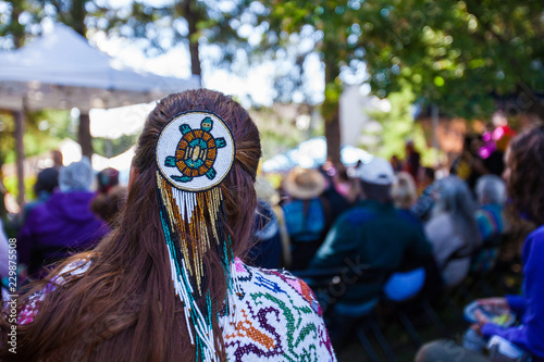 Fotografía Woman is wearing a large turtle beaded hair pin and colorful native clothing whi
